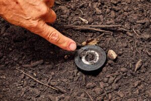 Technician pointing to faulty sprinkler valve
