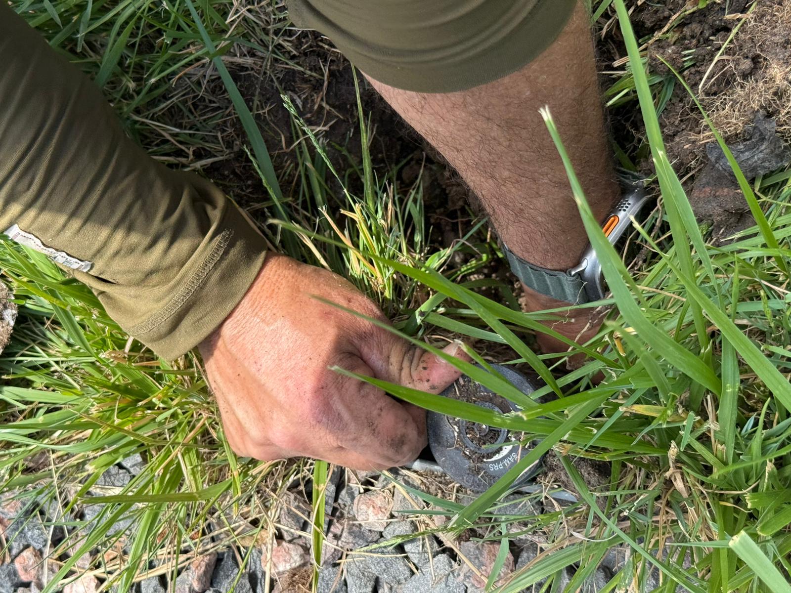 Man checking irrigation system troubleshooting and leak detection service