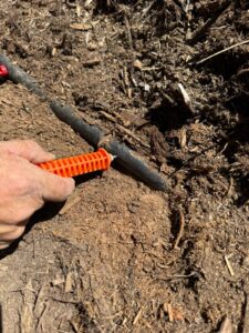Irrigation technician repairing residential sprinkler system in Castle Rock Colorado